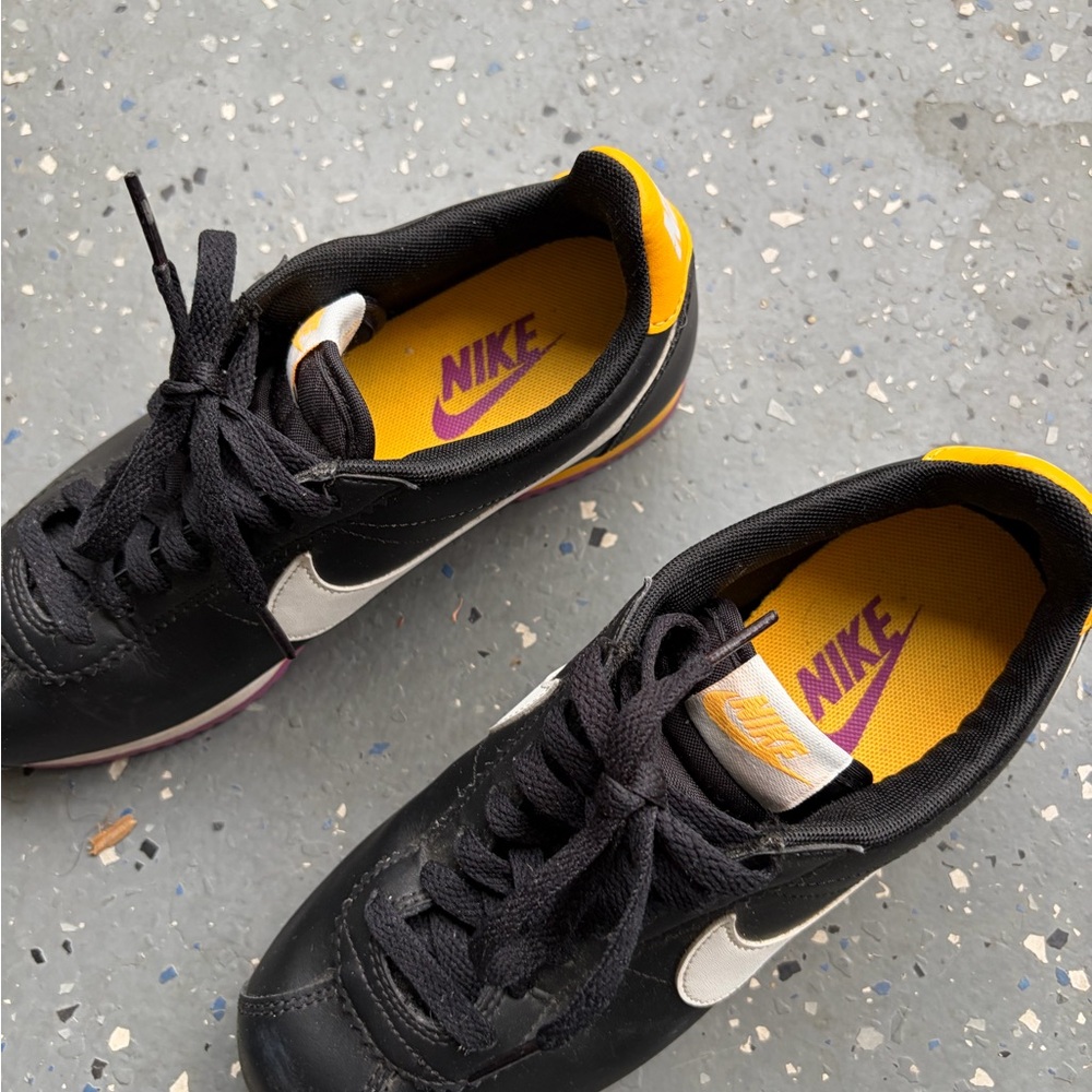 Nike Black Sneakers with White Swoosh and Yellow Insole